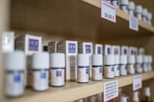white plastic bottles on brown wooden shelf