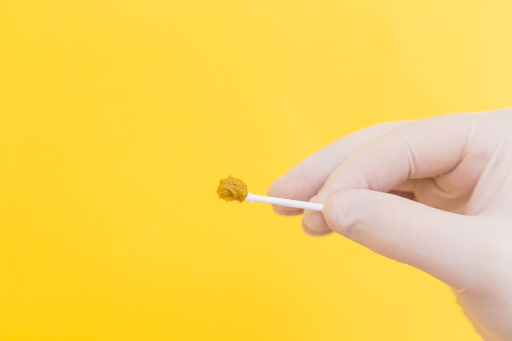 person holding white cotton buds