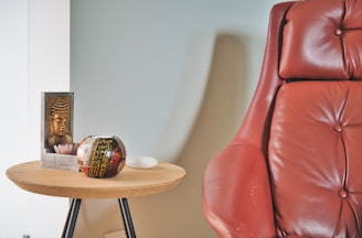 brown wooden table with red leather chair