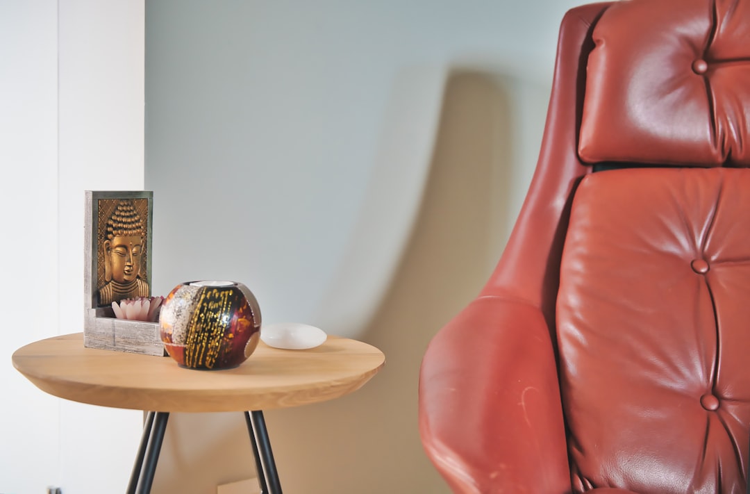 brown wooden table with red leather chair