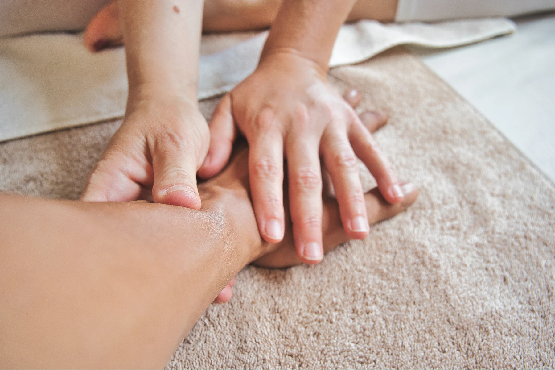 Peaceful close-up moment of hands during a spa treatment