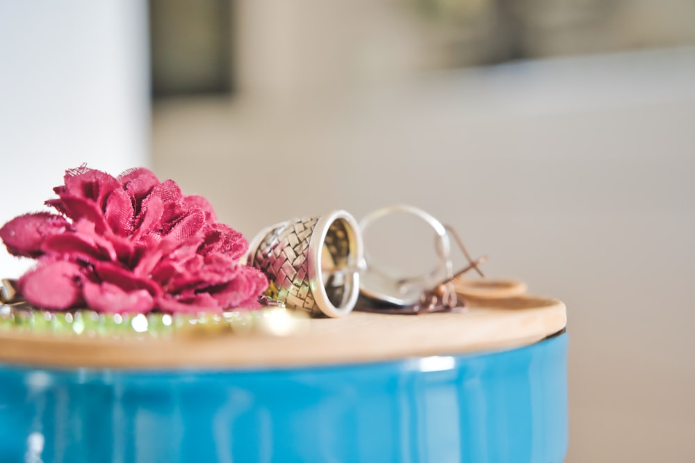 silver and gold rings on blue plastic container