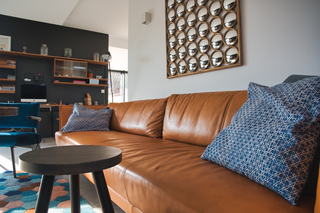 gray throw pillow on brown leather couch