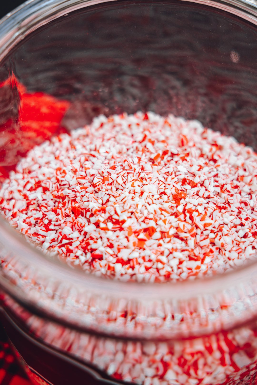 white and red candy on clear glass bowl