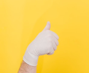 person in white long sleeve shirt holding right hand