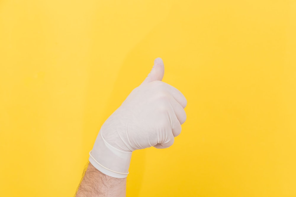 person in white long sleeve shirt holding right hand