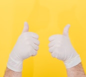 person in white long sleeve shirt doing thumbs up sign