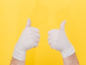 person in white long sleeve shirt doing thumbs up sign