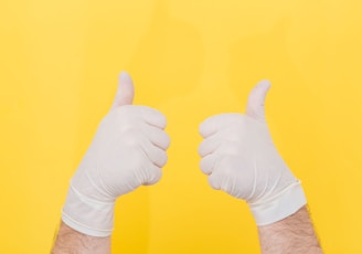 person in white long sleeve shirt doing thumbs up sign