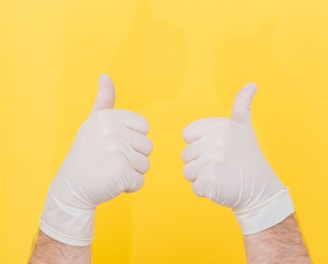 person in white long sleeve shirt doing thumbs up sign