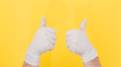 person in white long sleeve shirt doing thumbs up sign