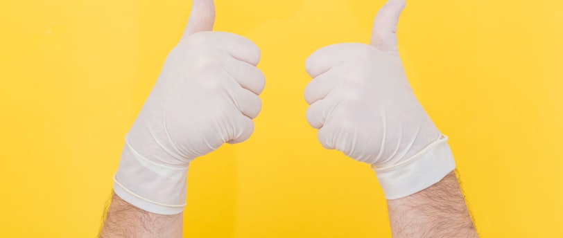 person in white long sleeve shirt doing thumbs up sign