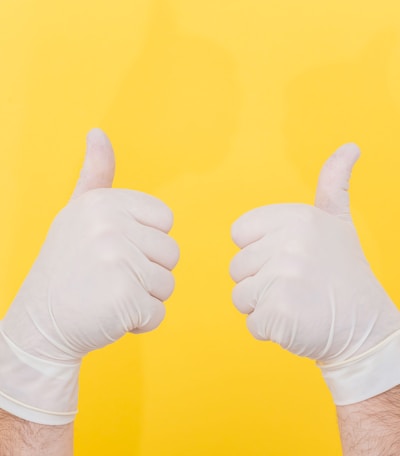 person in white long sleeve shirt doing thumbs up sign