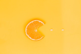 orange fruit on yellow surface