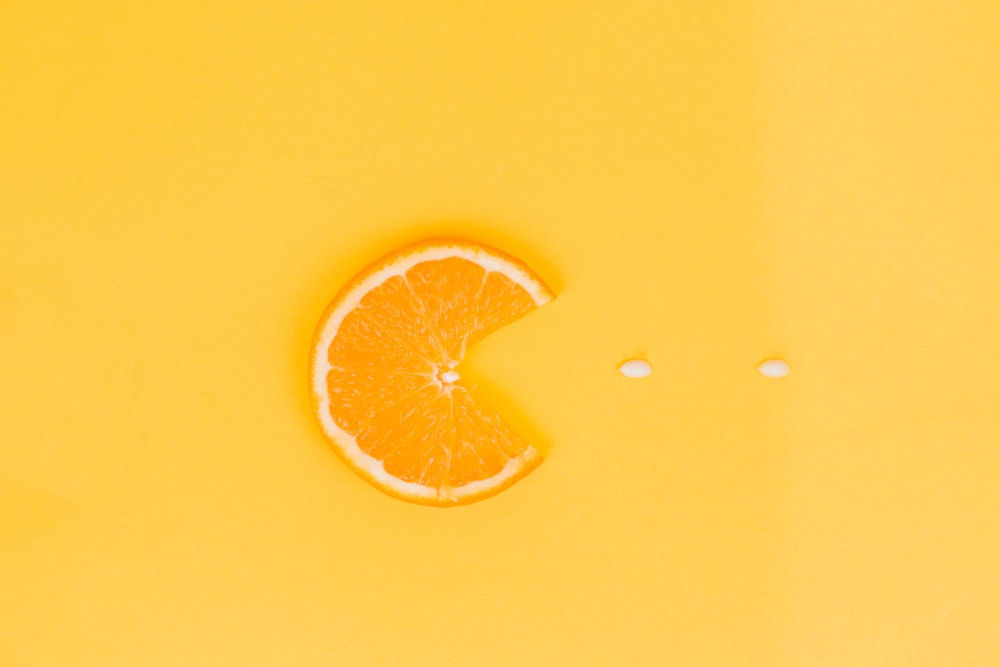 orange fruit on yellow surface