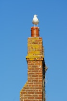 brown brick chimney under blue sky during daytime