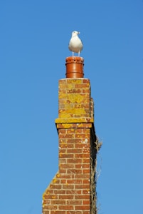 brown brick chimney under blue sky during daytime