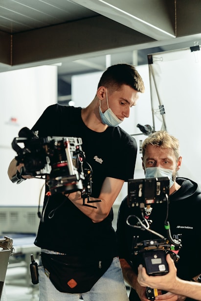 man in black crew neck t-shirt holding black and white robot toy