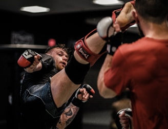 2 men in red and black boxing gloves