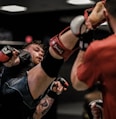 2 men in red and black boxing gloves