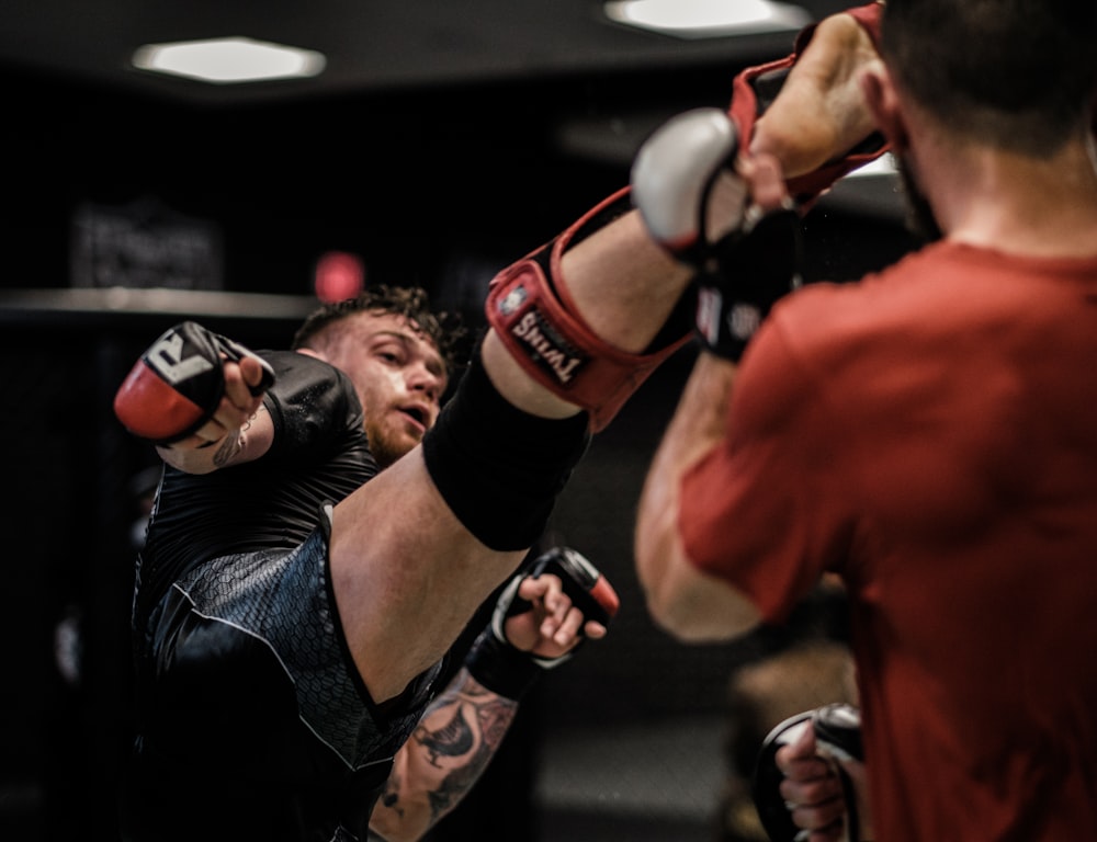 2 men in red and black boxing gloves