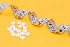 white round medication pill on yellow surface