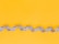 silver and black necklace on yellow textile