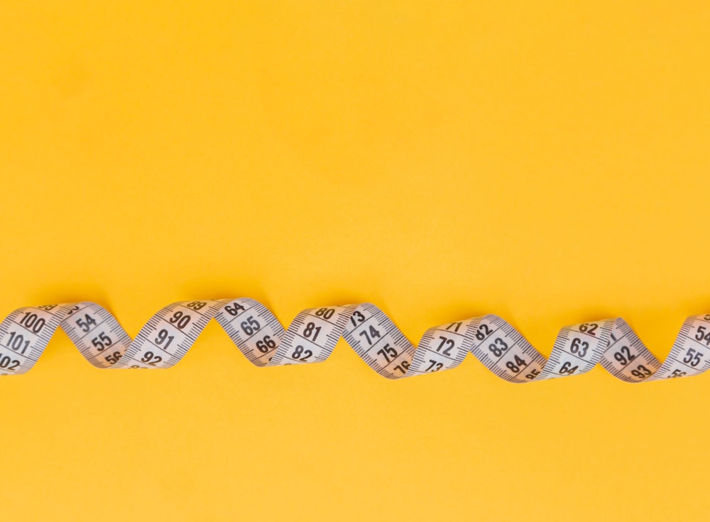 Fabric Measuring Tape In Yellow Stock Photo - Download Image Now - Tape  Measure, Weight Scale, Cut Out - iStock