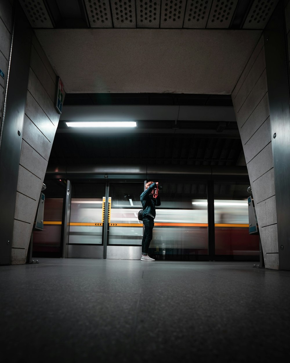 man in black jacket walking on hallway