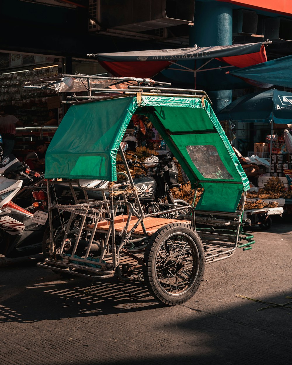 black and brown wooden cart on gray concrete road during daytime