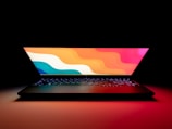 An open laptop with a vibrant screen showing a cityscape.