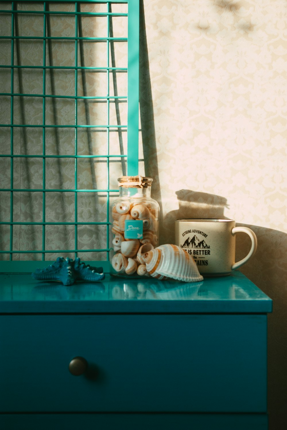 white ceramic mug on blue wooden table