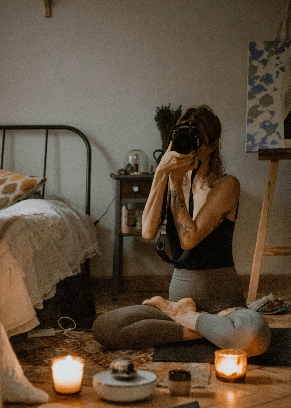 woman in black tank top sitting on bed