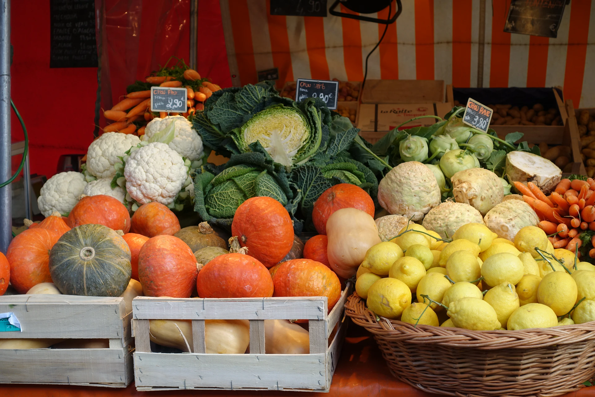 red apple fruit beside green vegetable on brown wooden crate