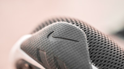 Close-up of Nike sportswear fabric texture highlighting breathable mesh and bold logo.