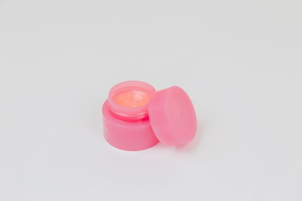 pink plastic round lid on white surface
