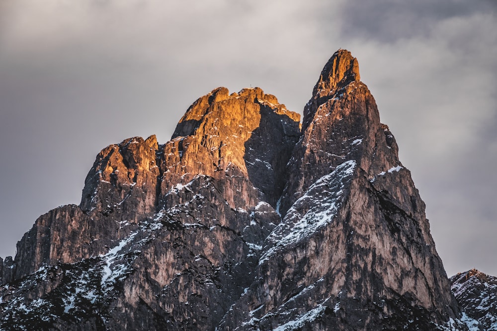 brown rocky mountain under cloudy sky during daytime