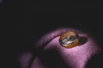 Close-up of a hand about to click a bright, inviting button on an image.