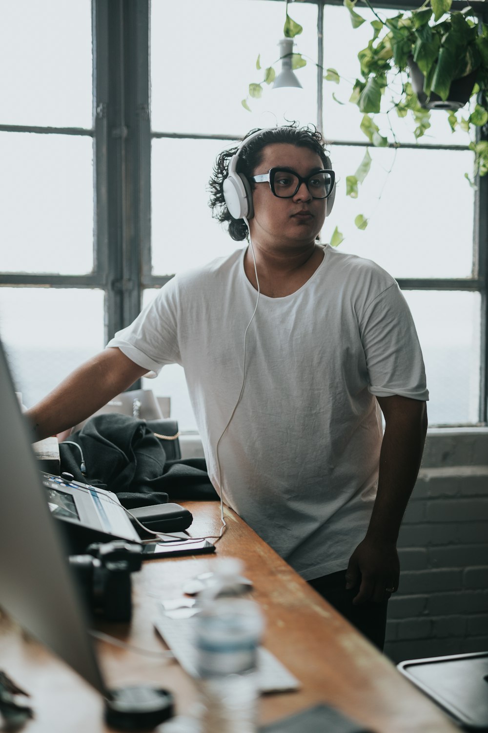 man in white crew neck t-shirt wearing black framed eyeglasses