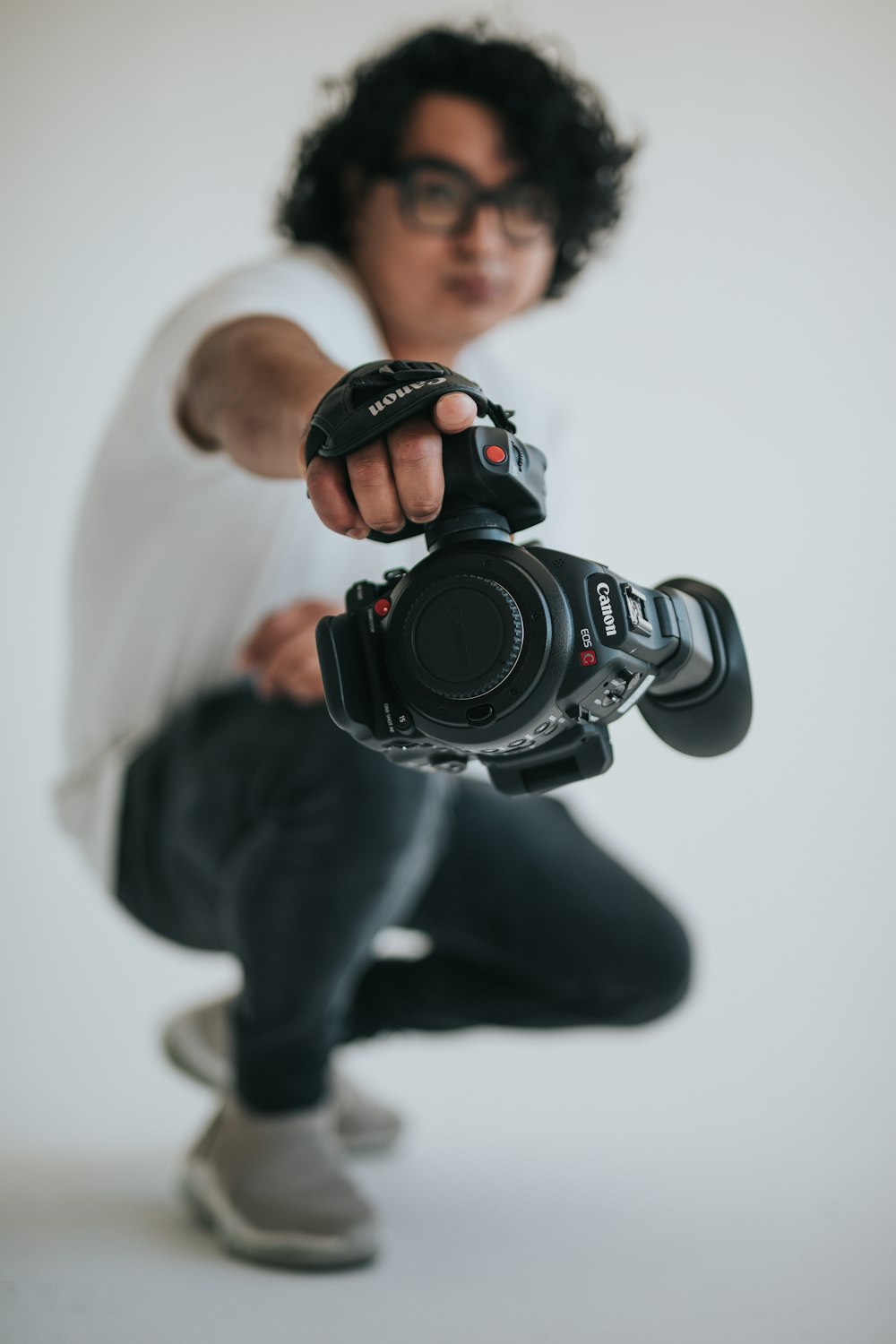 man in black jacket holding black nikon dslr camera