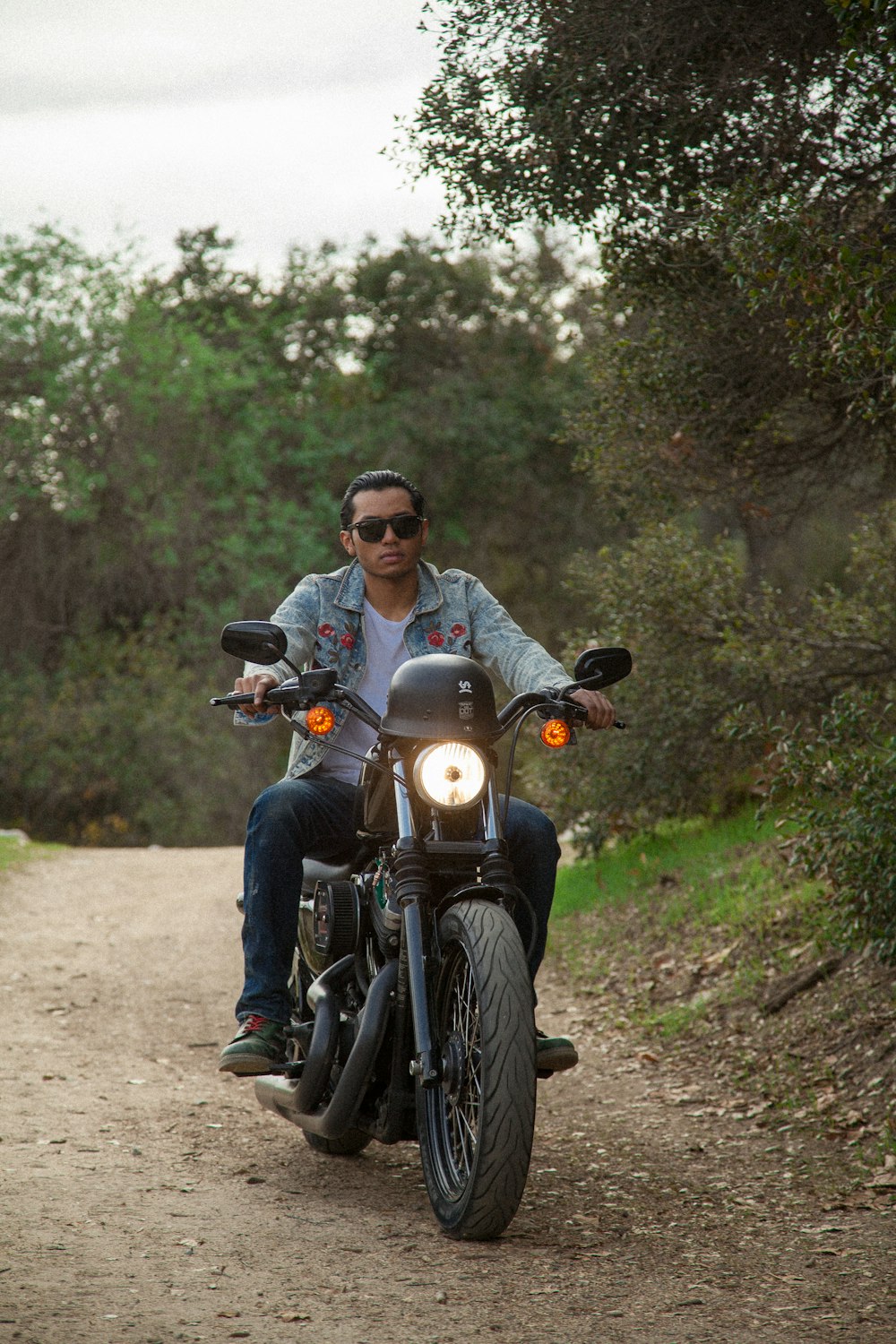 man in gray jacket riding on black motorcycle