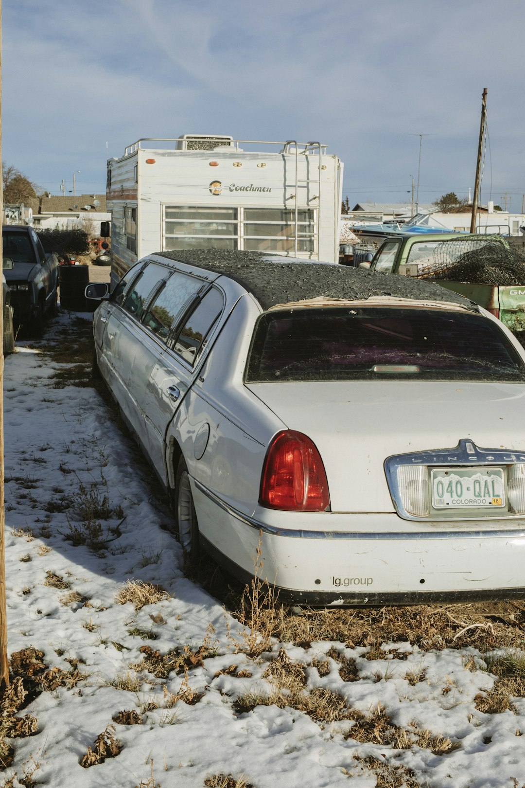 white sedan on road during daytime