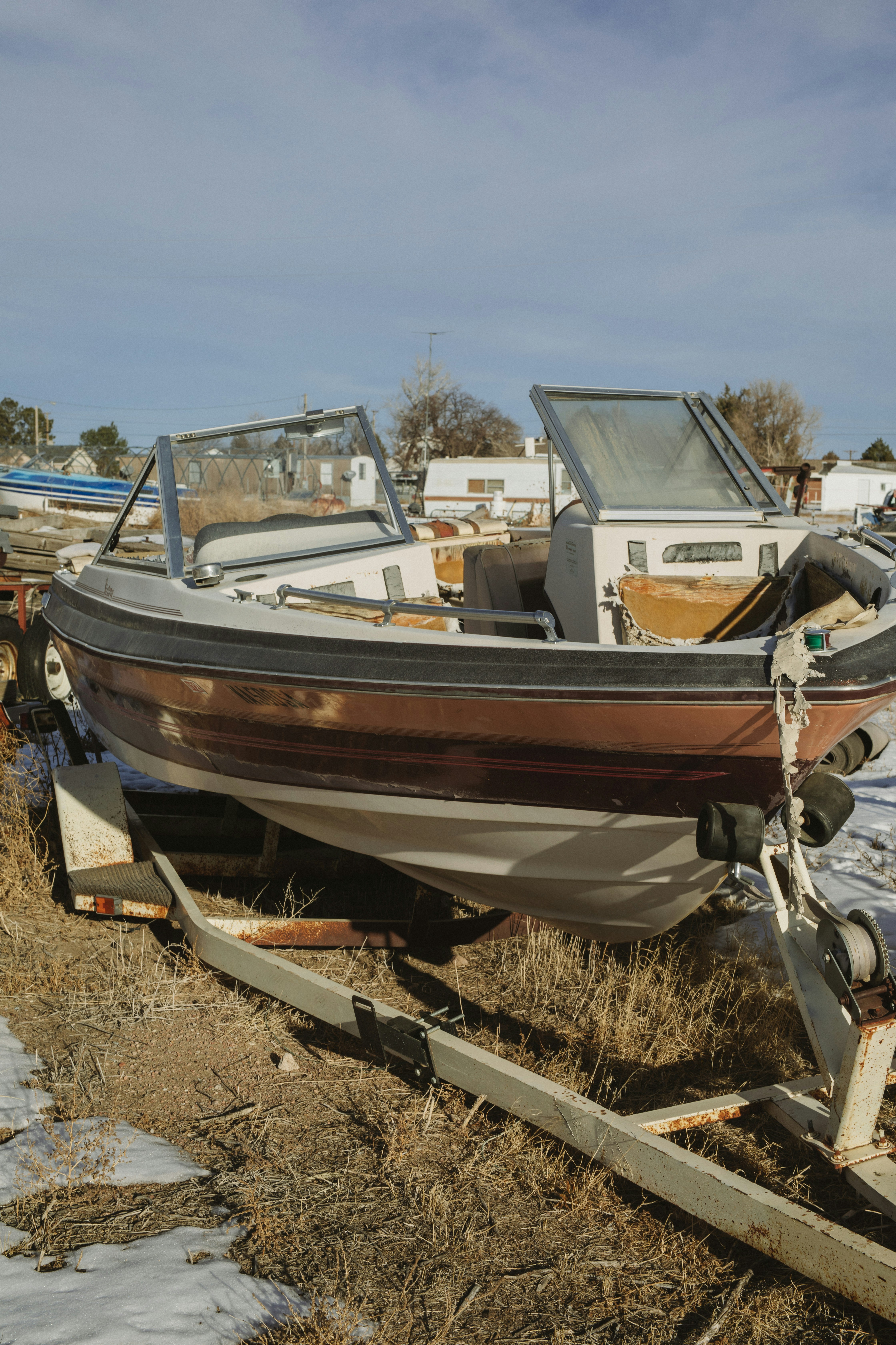 white and brown boat on brown soil during daytime