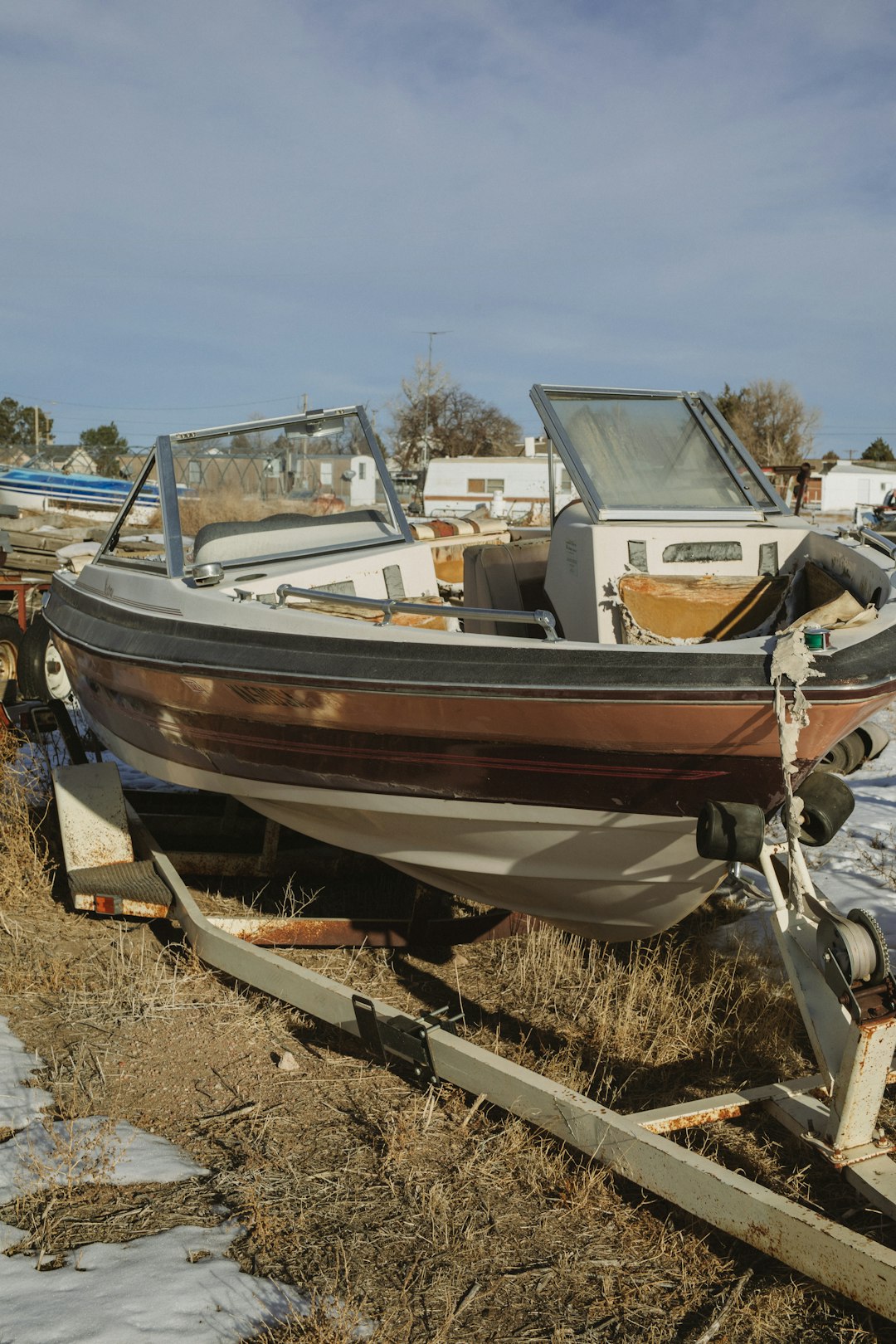 white and brown boat on brown soil during daytime