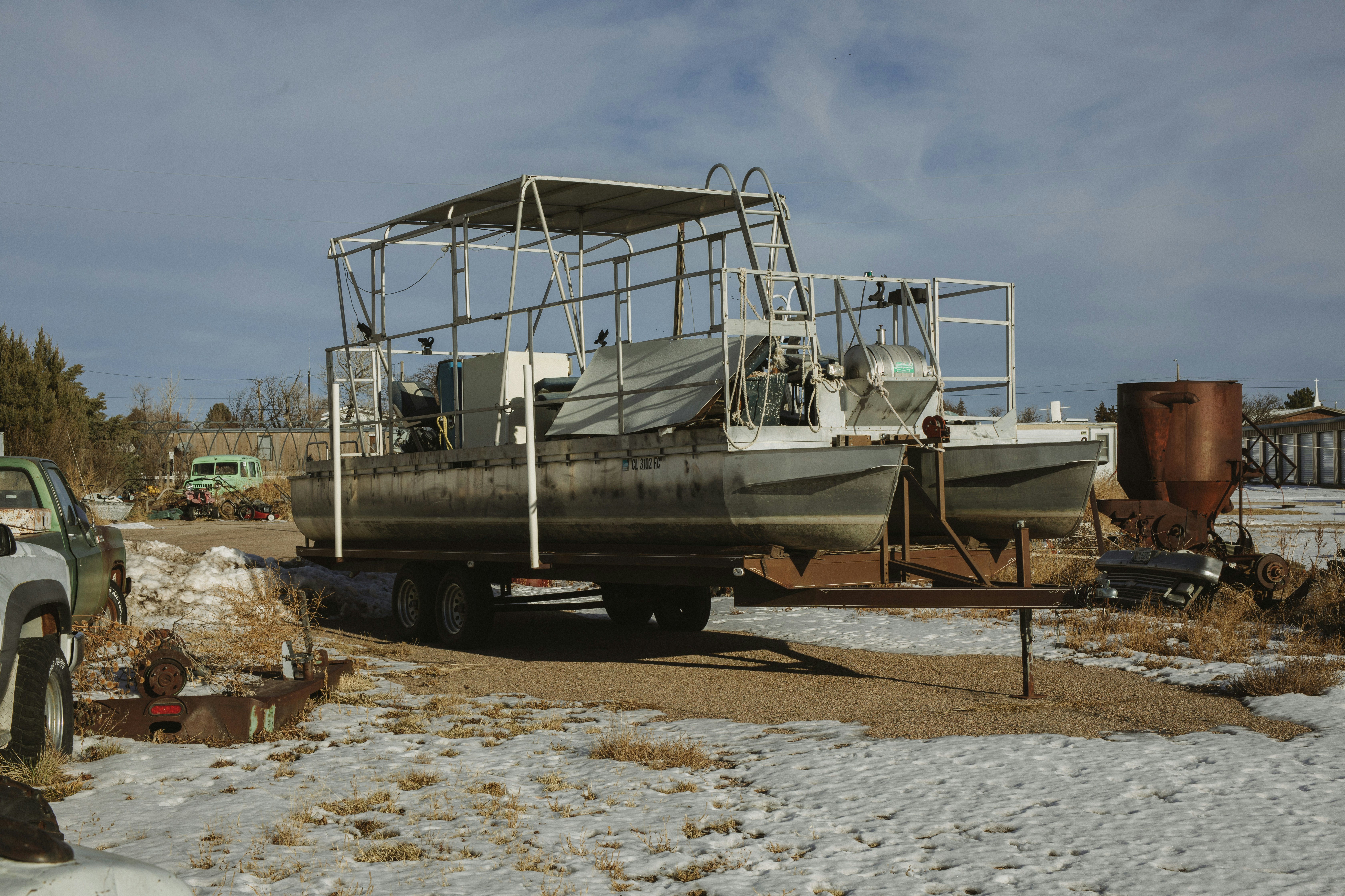 white and black boat on beach shore during daytime