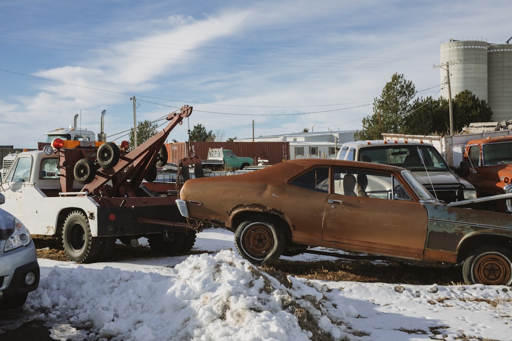 brown and white vintage car on snow covered ground during daytime