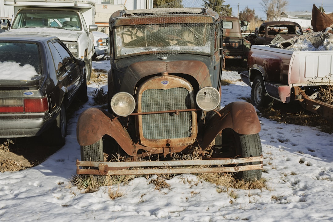 brown vintage car on snow covered ground during daytime