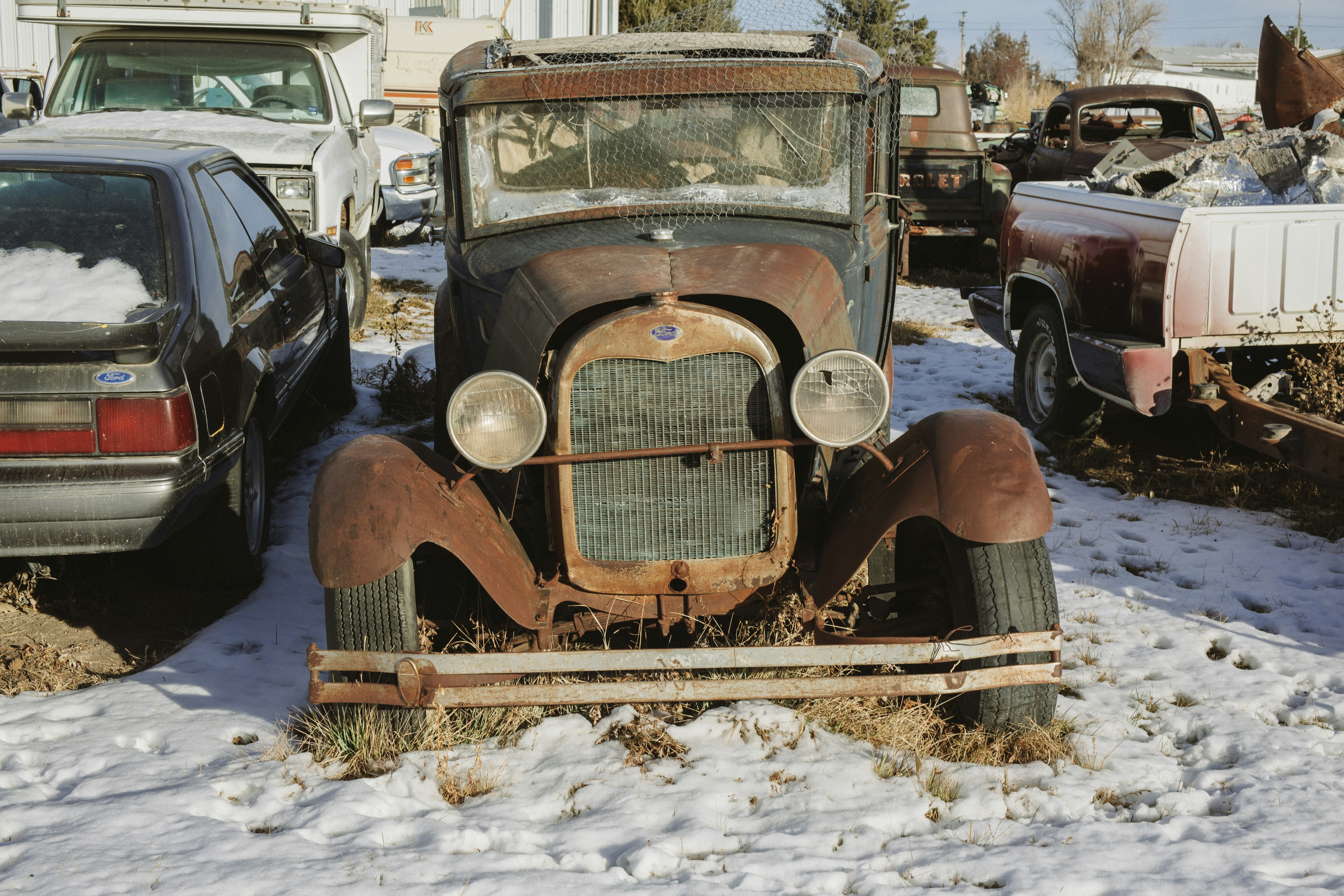 brown vintage car on snow covered ground during daytime