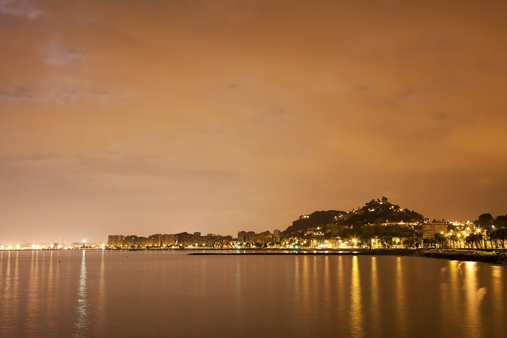 body of water near city buildings during daytime