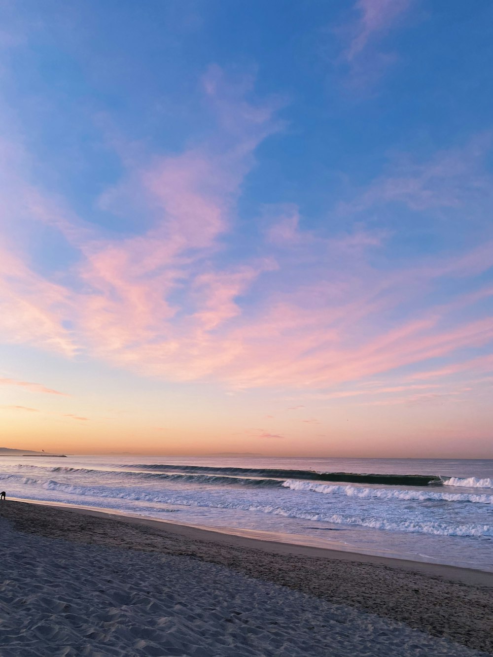 body of water under blue sky during sunset